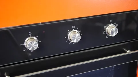 Close up view. Glass front panel of modern electric oven with shiny button Stock Footage 91666312