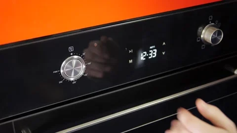 Close up view. Glass front panel of modern electric oven with shiny button Stock Footage 91666380