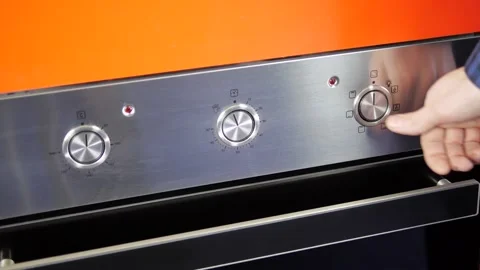 Close up view. Glass front panel of modern electric oven with shiny button Stock Footage 91666386