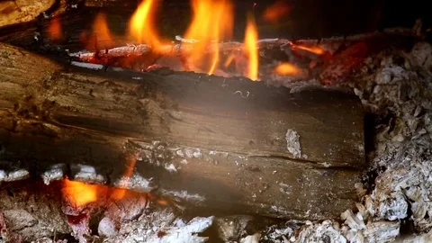 Close view at a glowing charcoal and flame in the barbecue grill. Shallow depth Stock Footage 77493652