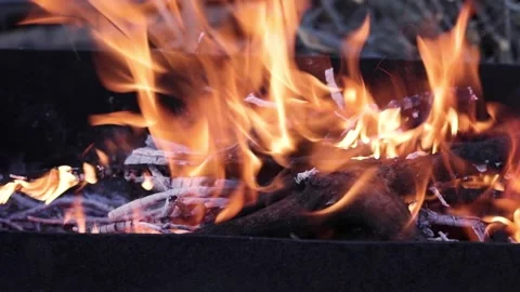 Close up view of glowing flying fire flame from hot bonfire charcoal. Stock Footage 130182121