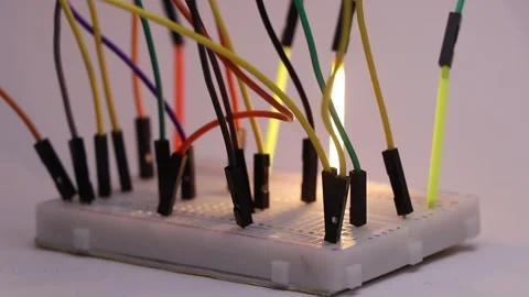 Close up view of glowing LED filament tube lights connected to breadboard Stock Footage 336626581