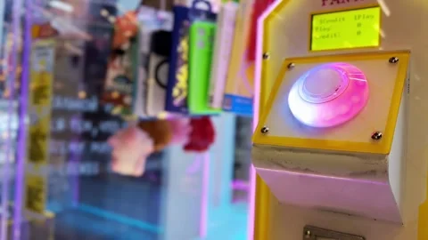 Close up view of glowing play button on arcade claw machine, button changing Stock Footage 344846066