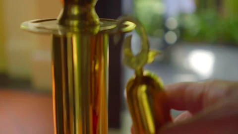 Close-up view of gold queue barrier posts with  twisted red rope Stock Footage 116491283