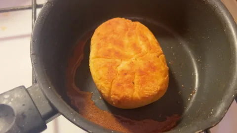 CLose-up view golden crispy fried patty on a frying pan in kitchen at home Stock Footage 280321711