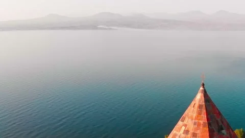 Close up view golden cross on top church dome with scenic lake landscape outd Stock Footage 164370185