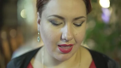 Close up view of good looking middle aged brunet woman eating berry enjoying mea Stock Footage 137537370