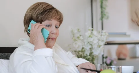 Close up view of good looking old woman talking and eating strawberry while Stock Footage 127177443