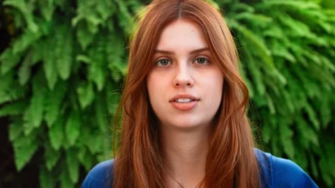 Close-up view of good-looking serious young woman with ginger hair. Video stock 265197142