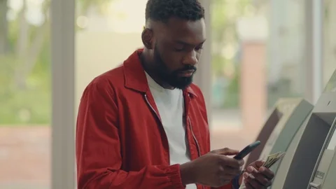 Close up view of good-looking young Afro-American man holding transferred cash Stock Footage 111220848