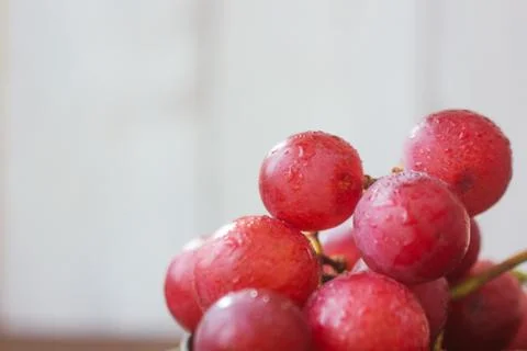 Close view of grapes over the white background. Stock Photos