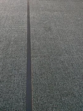 Close up view of gray carpet texture with a dark vertical stripe Foto stock