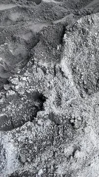 Close up view of a gray sand pile with varied grain texture and small footpri Foto stock
