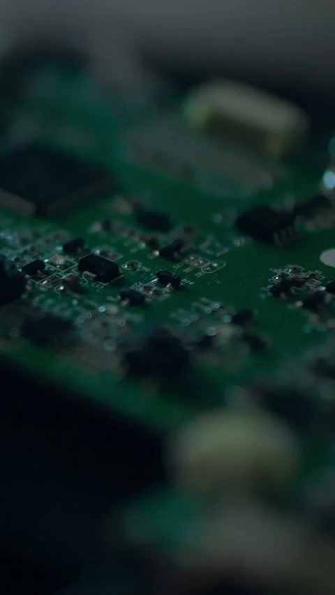 Close up view of green circuit board with electronic components illuminated Stock Footage 331538561