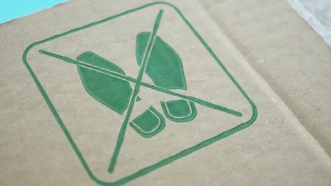 Close up view of the green do not step symbol on brown cardboard box surface. Stock Footage 332192410