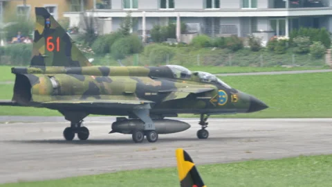 Close view of a green mimetic Saab 37 Viggen Swedish military aircraft taxiing 動画素材 146459597