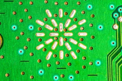 Close-up view of a green printed circuit board with intricate patterns and .. 写真素材