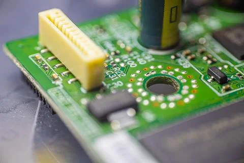 Close-up view of a green printed circuit board featuring various electronic.. Stock Photos