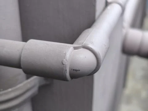 Close-up View of a Grey Plastic Drainage Pipe with an Elbow Joint Stock Photos