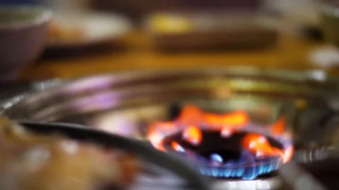 Close up view of grill stove with fire and stove top full of seafoods on fire. Stock Footage 149553068