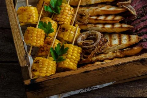 Close view of grilled corn and onion rings Stock Photos