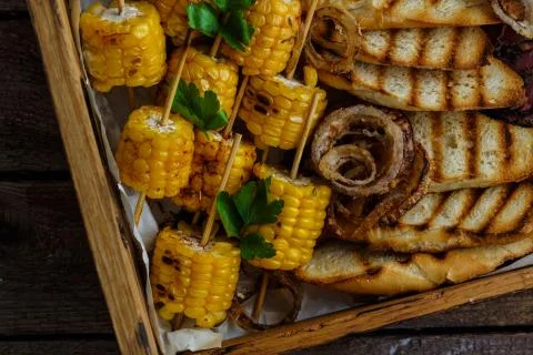 Close view of grilled corn and onion rings Stock Photos