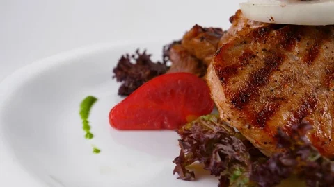 Close-up view of Grilled Lamb or veal chop with vegetables Stock Footage 79712210