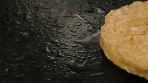 Close-up view of grilling burger cutlet, camera moves to right Stock Footage 76897648