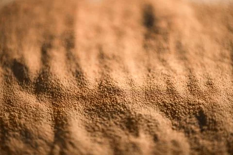 Close-up view of ground chicory root powder, revealing its rich brown color a Stock Photos