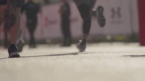 Close-up view from the ground in the frame only legs, a crowd of people running Video stock 226809313