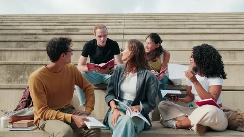 Close up view of the group of happy students with study items is sitting on the Stock Footage 297617172