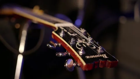 A close-up view of a guitar headstock, showcasing its intricate details and craf Stock Footage 319480084