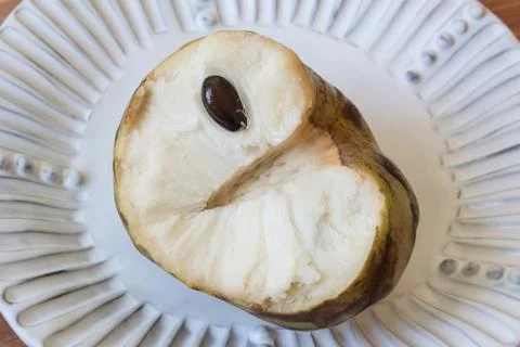 Close view of half of a cherimoya fruit Annona cherimola revealing impression Stock Photos