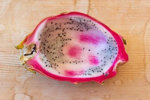 Close view of half of a dragon fruit with pulp spooned out, centered Stock Photos