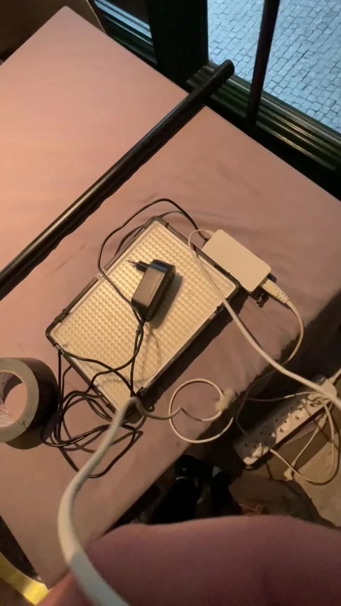 Close view of hand adjusting extension cord and power strip setup Stock Footage 335435621