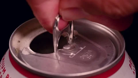 Close-up view of a hand carefully opening the pull-tab of a cold canned beer Stock Footage 314793520