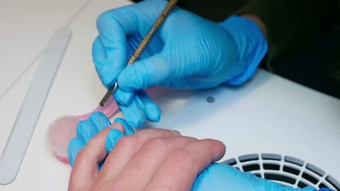 Close up view of hand during procedure of manicure. Manicurist pushes back Stock Footage 146645217
