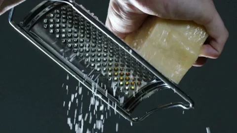 Close up view of hand grating cheese with a stainless steel grater Stock Footage 310110742