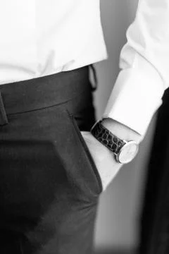 Close-up view of the hand with hand watch of the groom in the pocket. Photo in Stock Photos