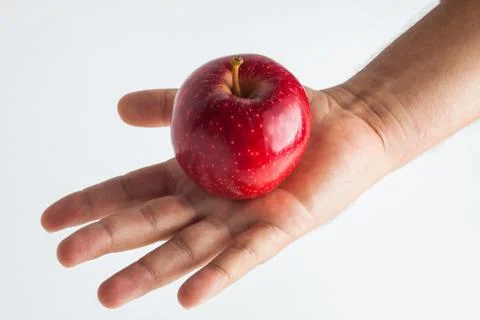 Close-up view of a hand holding apple on a white background Stock Photos