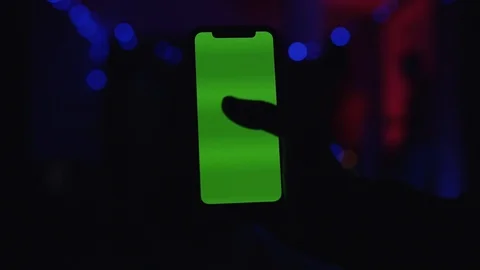 Close up view of a hand holding modern green chroma key blank screen smartphone Stock Footage 111221240