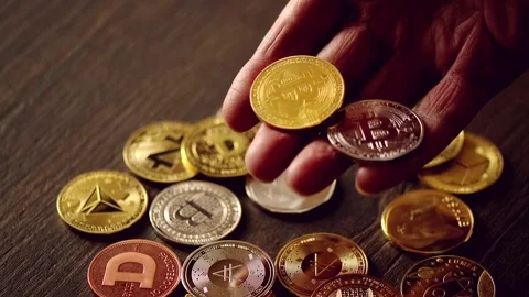 A close up view of a hand holding two crypto coins, bitcoin and other crypt.. 스톡 동영상 339415838
