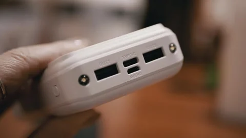 Close Up View Of Hand Holding White Power Bank Showing USB Charging Ports 스톡 동영상 332664424