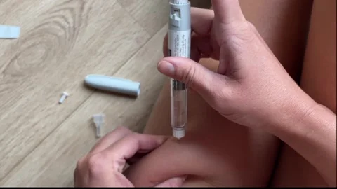 tirzepatide videos Close-up view of a hand selecting a doze... | Stock Video
