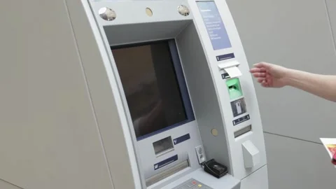 Close-up view of hand inserting a credit card into an ATM teller machine ca.. Stock Footage 272756929