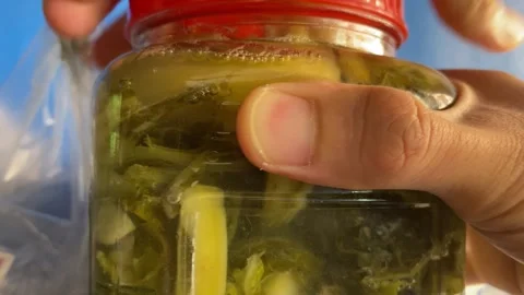 Close up view hand open glass jar cover DIY homemade fermented vegetable Video stock 274525759