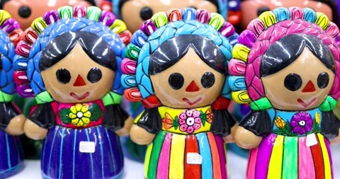 Close up view of hand-painted ceramic Mexican doll piggy banks up for sale .. Stock Footage 324014027