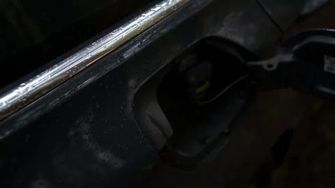 Close up view of hand of person opening fuel tank flap of black car surface 스톡 동영상 325296390