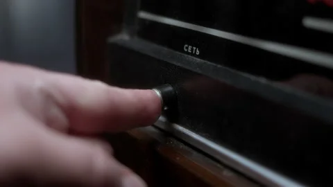 Close up view of hand pressing power button on dusty old vintage radiol Stock Footage 237117873