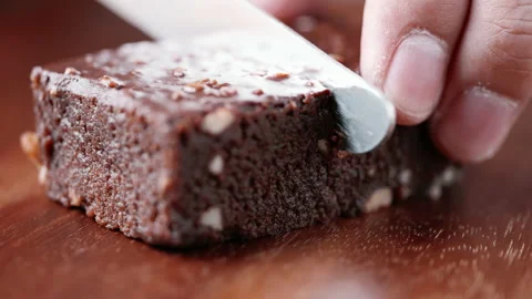 Close up view of hand slicing brownie in slow motion Stock Footage 151614930